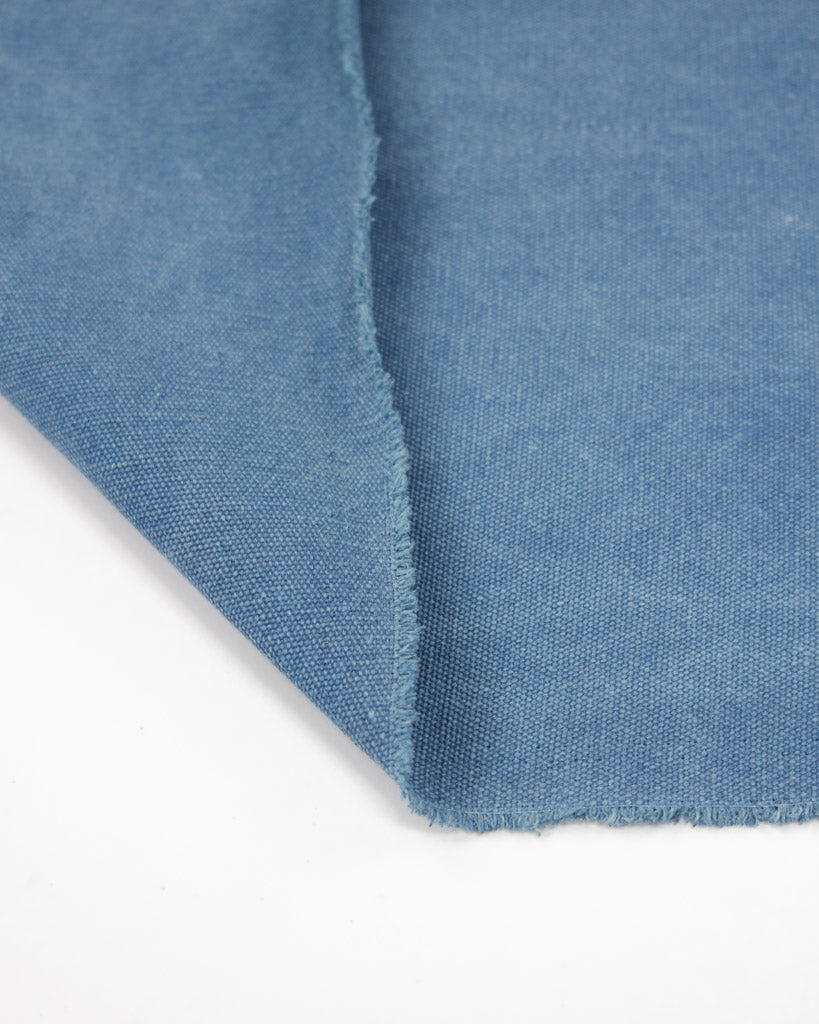Selvedge edge of heavy cotton blend canvas fabric in blue