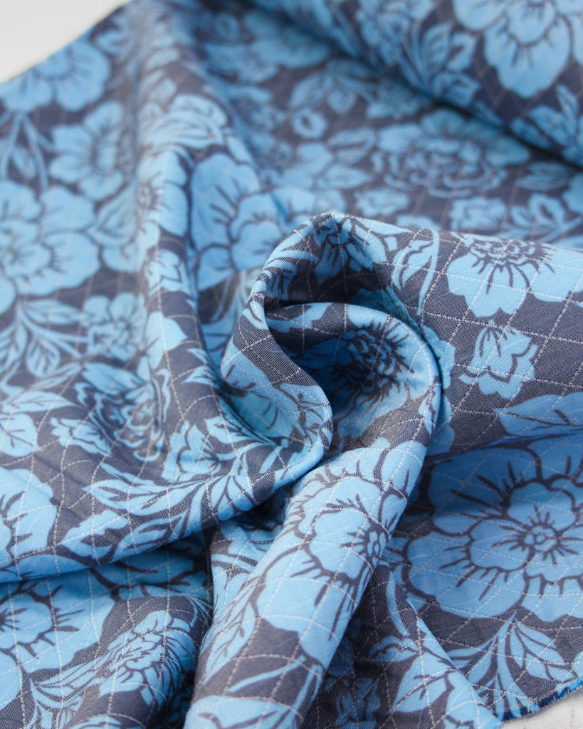 Blue and gray floral patterned quilted fabric