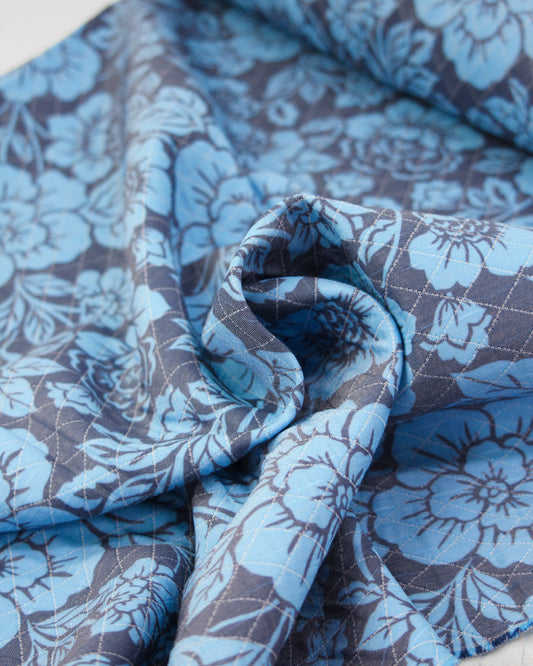 Blue and gray floral patterned quilted fabric