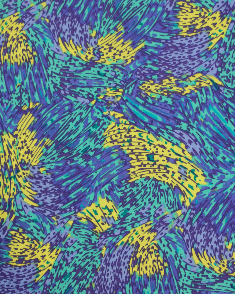 Colourful abstract pattern viscose fabric with blue, green, and yellow colours.