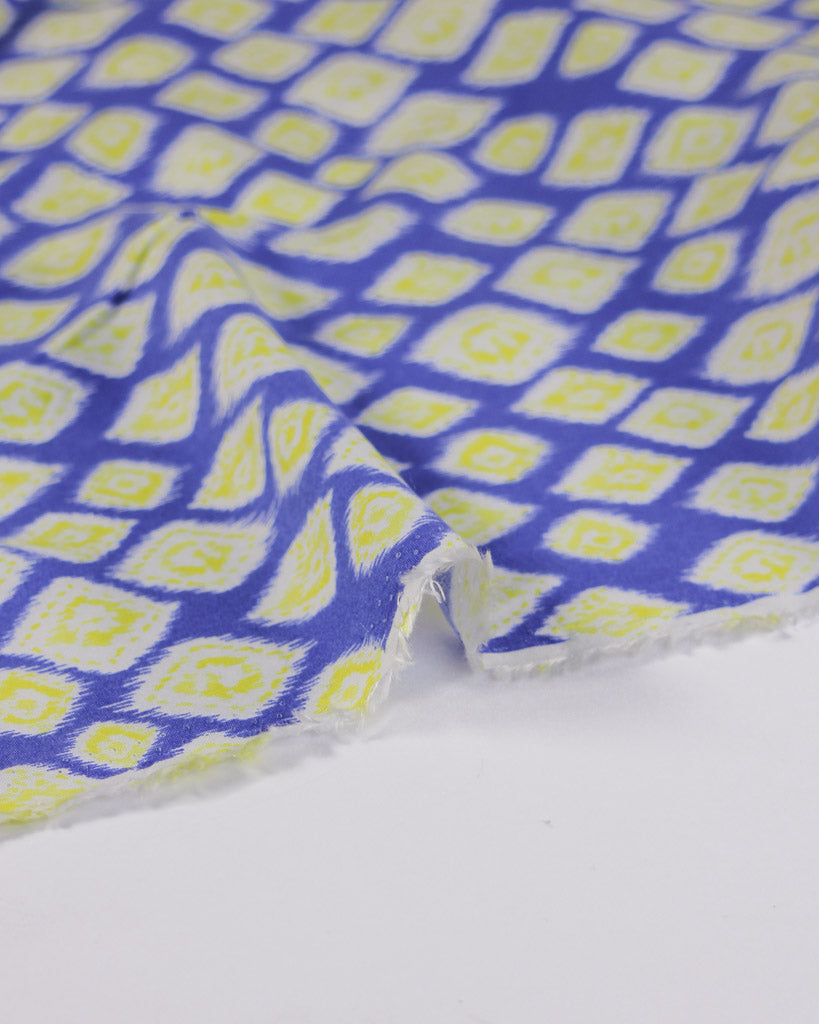 Viscose lawn fabric with blue and yellow diamond pattern on a white background