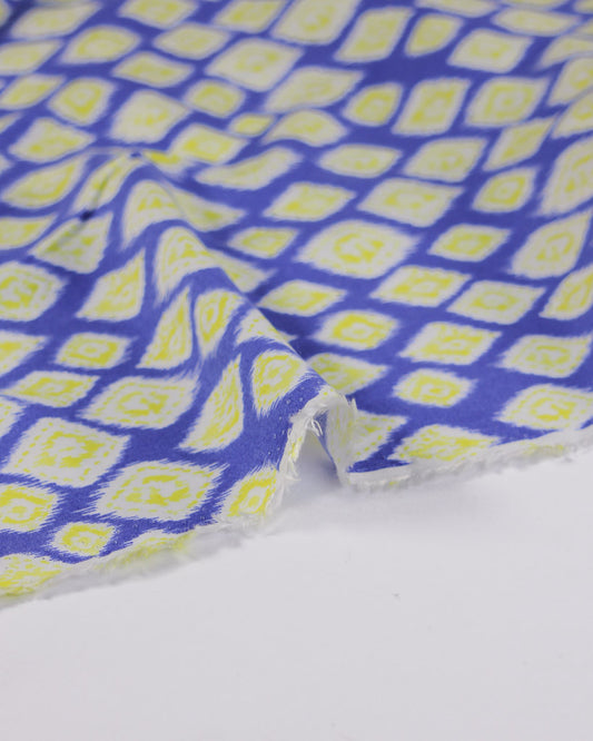 Viscose lawn fabric with blue and yellow diamond pattern on a white background