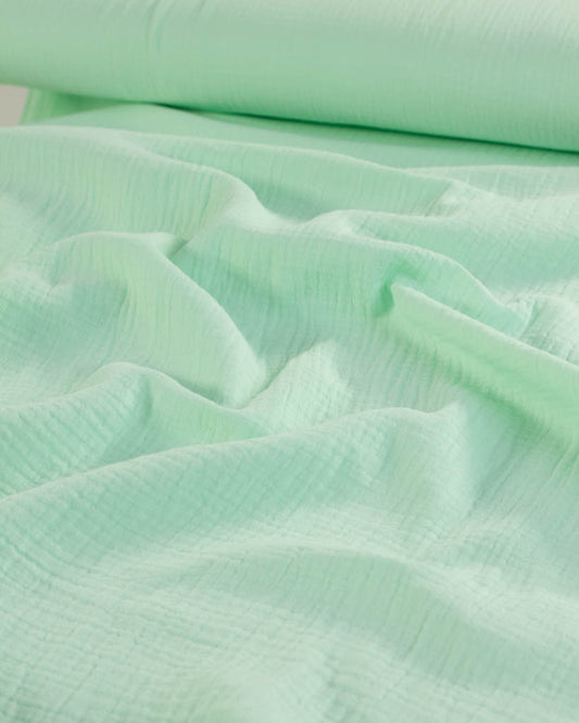 Close-up of light mint green cotton double gauze fabric