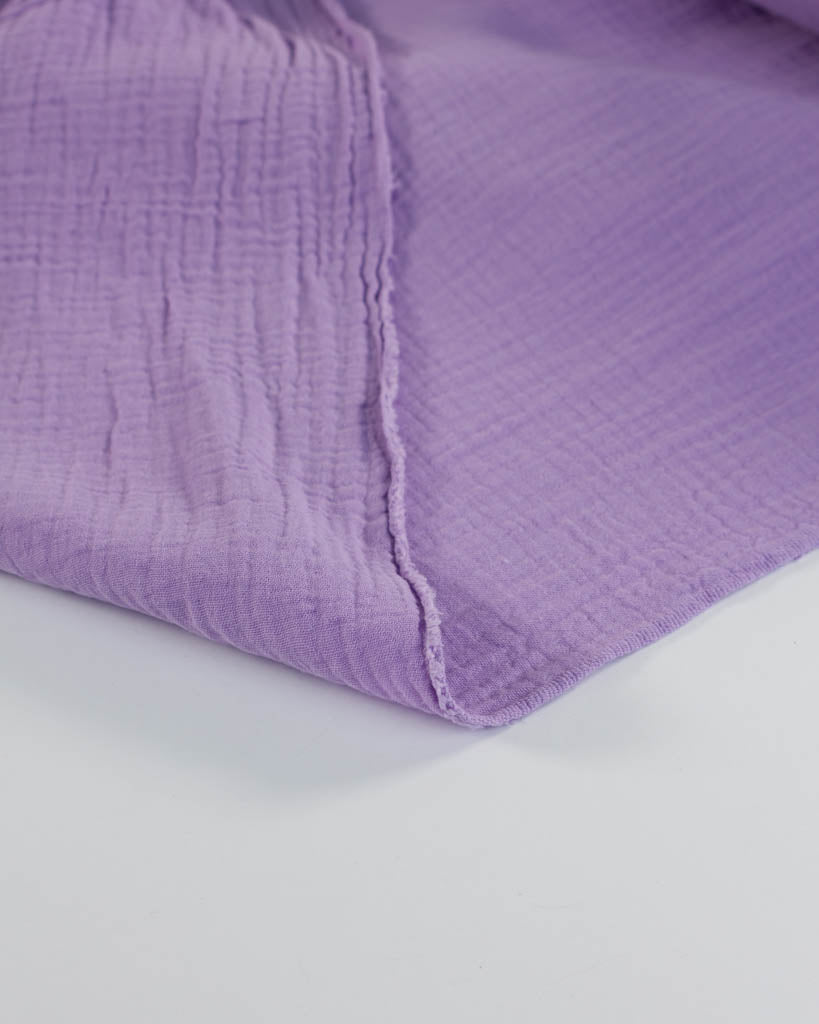 Pale purple cotton double gauze fabric on a white background
