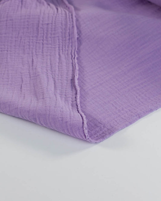 Pale purple cotton double gauze fabric on a white background