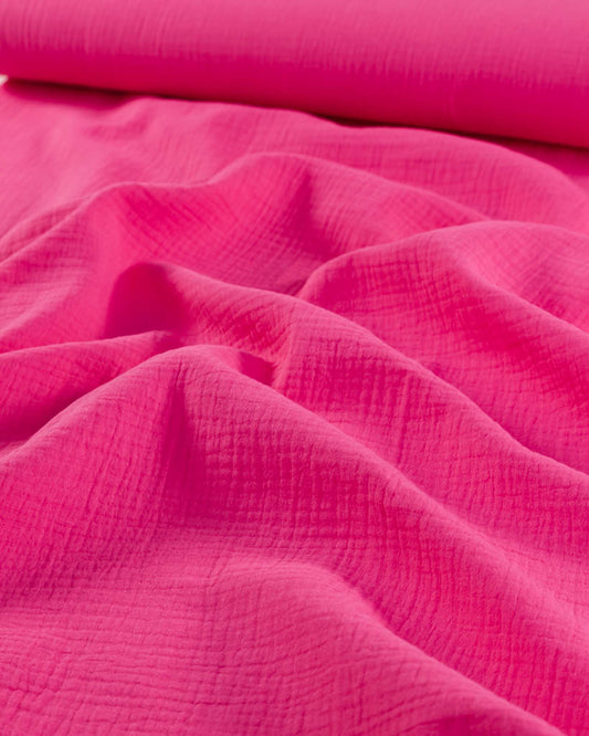 Close-up of hot pink cotton double gauze fabric