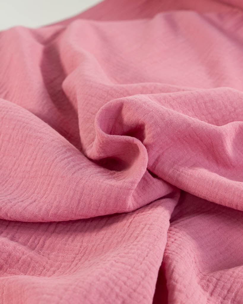 Close-up of Peony pink cotton Double Gauze fabric with a soft texture