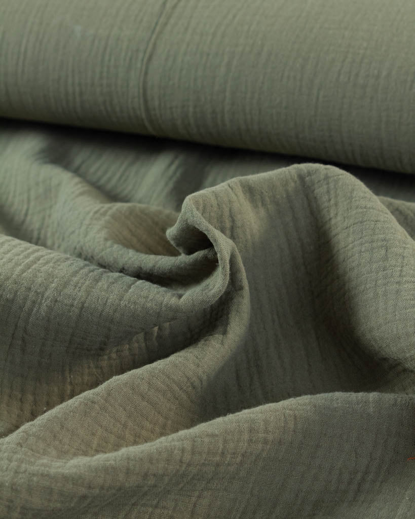 Close-up of cotton double gauze in green fabric with folds
