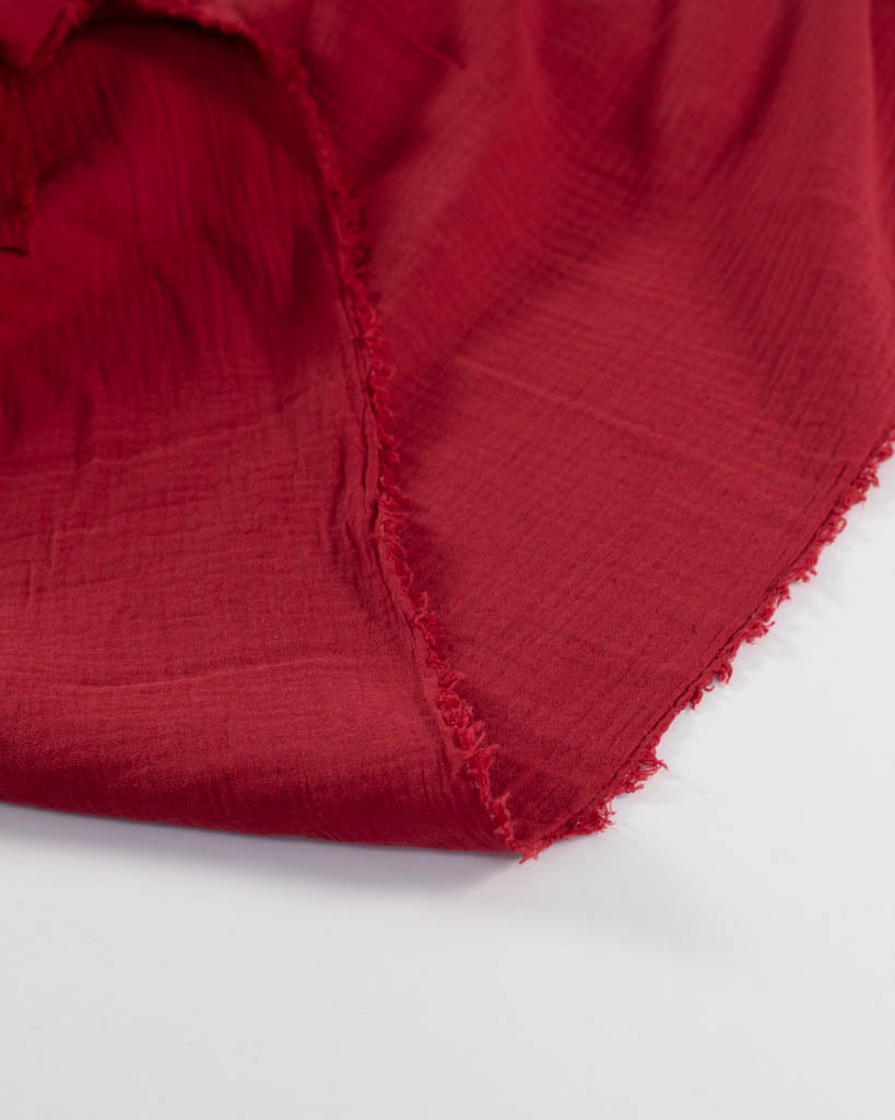 Red cotton double gauze fabric on a white background