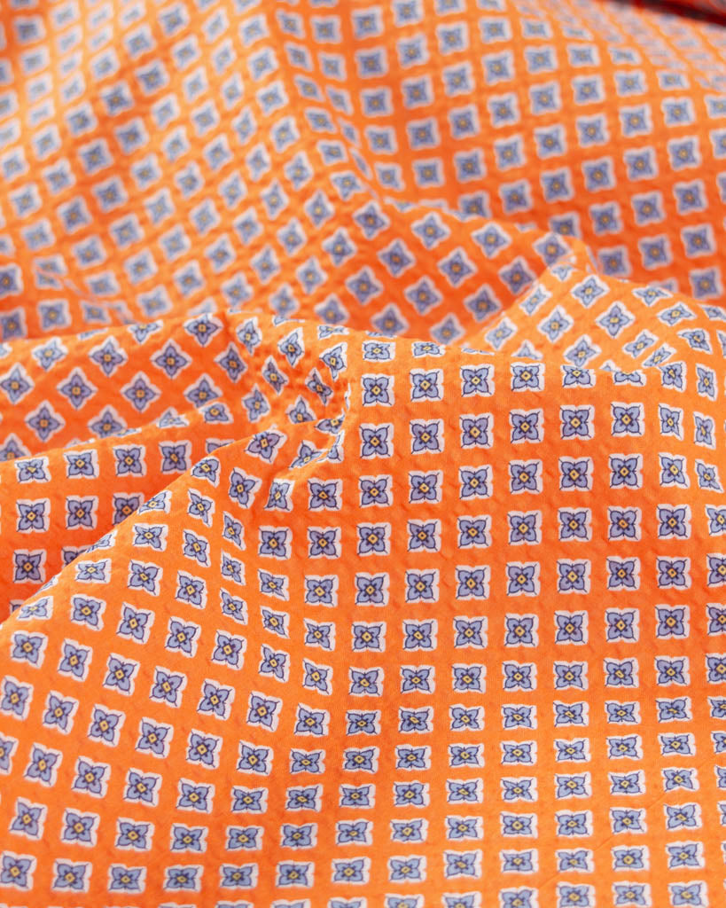 Mango orange cotton seersucker fabric with small floral tile print