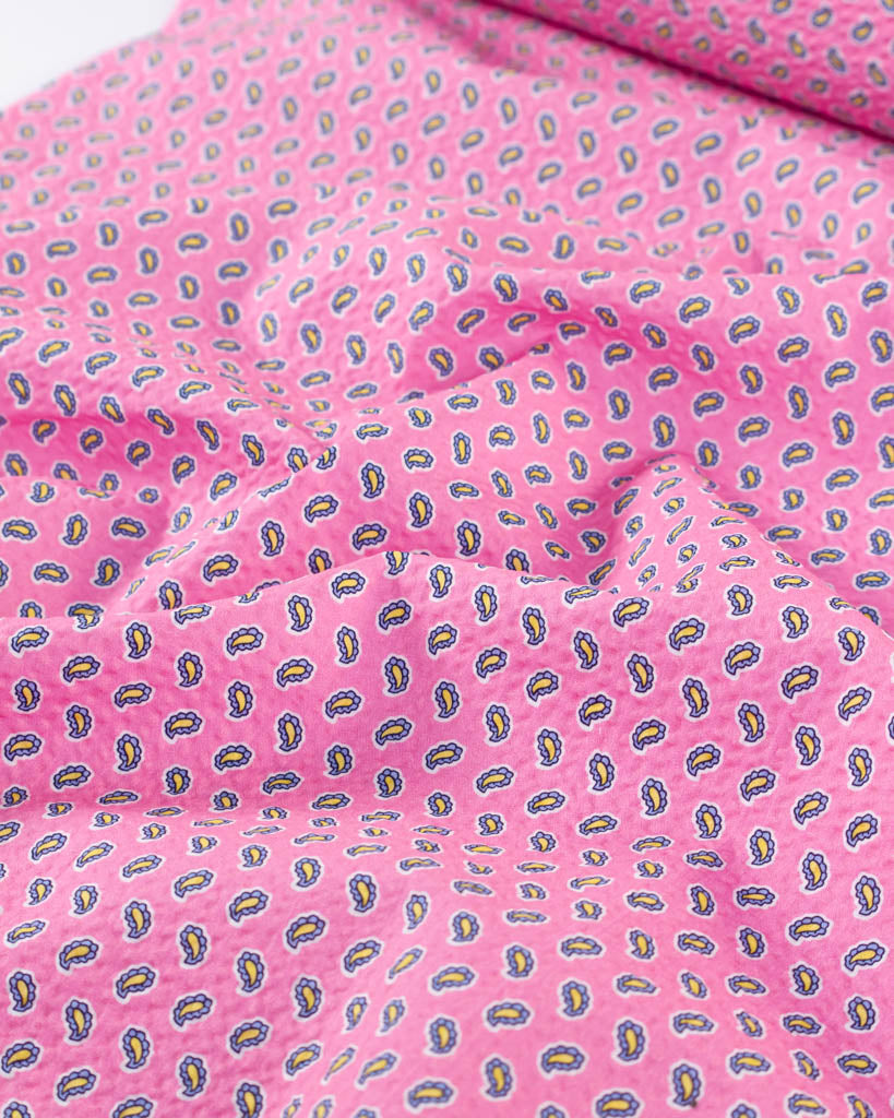 Rippled view of Posy Cotton Seersucker in Bubblegum pink with a tiny paisley print