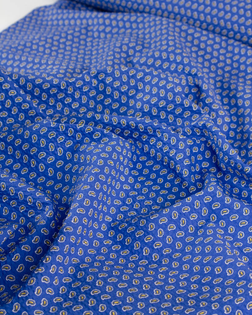 Huckleberry blue cotton seersucker fabric with a delicate paisley print