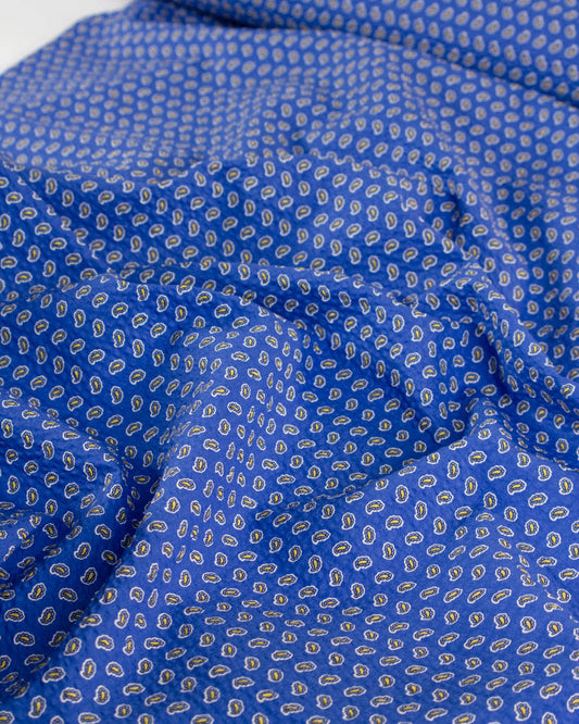 Huckleberry blue cotton seersucker fabric with a delicate paisley print