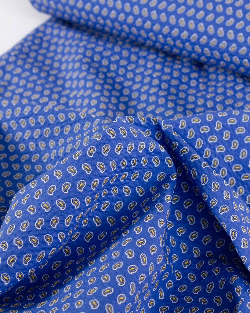 Deadstock cotton seersucker in huckleberry blue with a vintage-style tiled paisley print