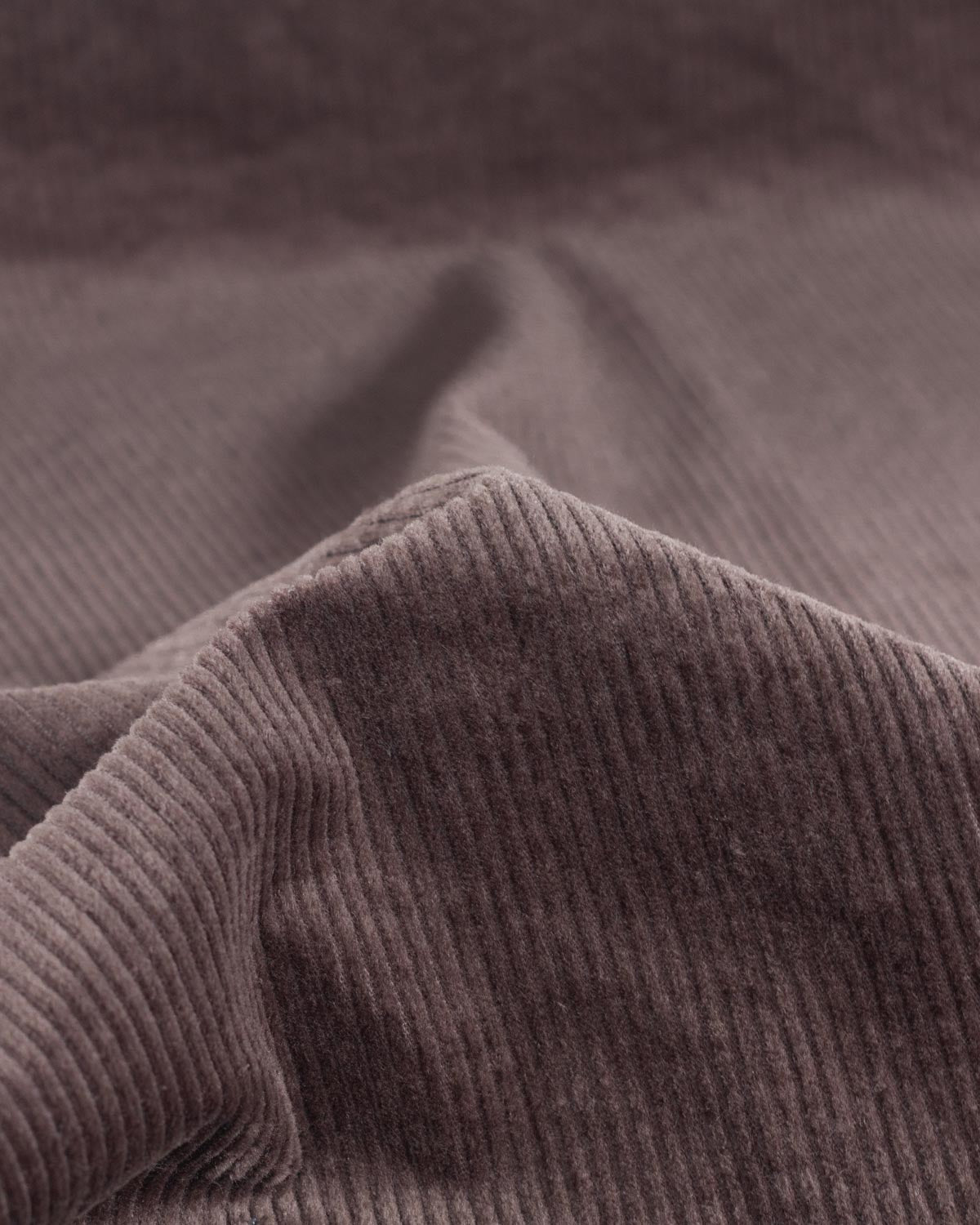 Close up of a cotton corduroy fabric in a brown shade