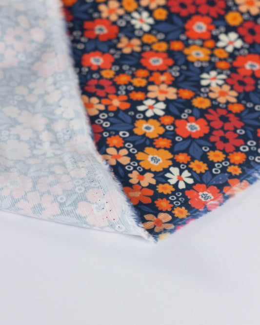 Folded floral cotton babycord fabric showing the plan reverse.