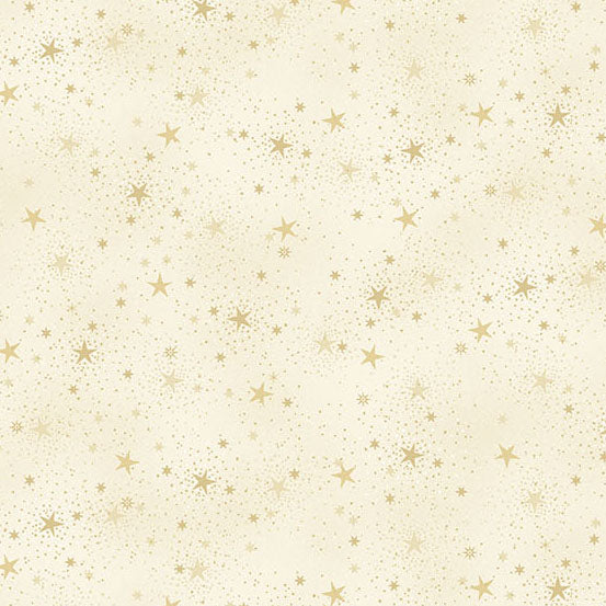 Pattern of small gold stars on a cream quilting cotton