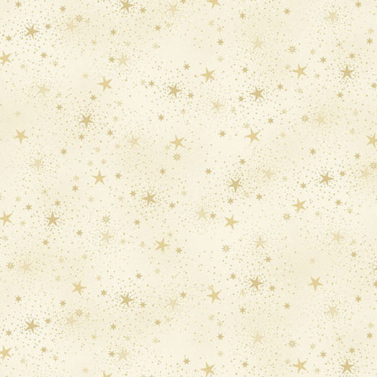 Pattern of small gold stars on a cream quilting cotton