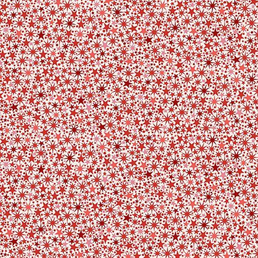 Pattern of red and white stars on a cream quilting cotton