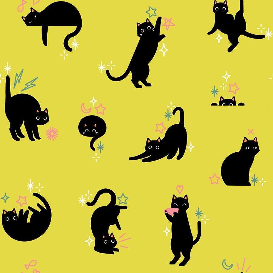 Pattern of black cats on a yellow cotton with colorful accents