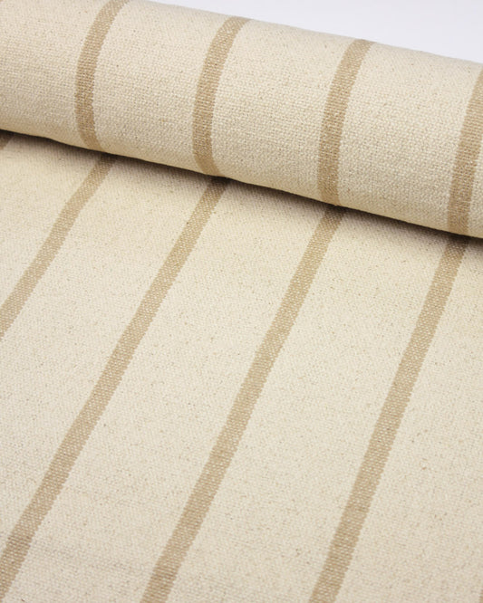 A close-up of a woven cotton upholstery fabric with a cream base and vertical beige stripes