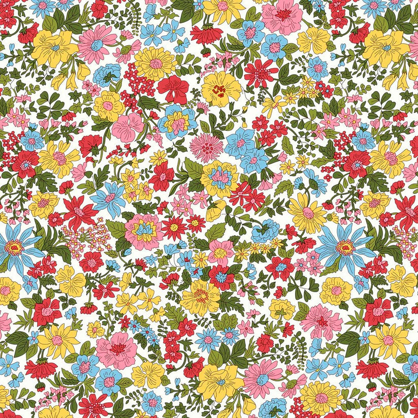 Colorful floral pattern in blues, pinks, yellows, and reds amidst green foliage on a white quilting cotton