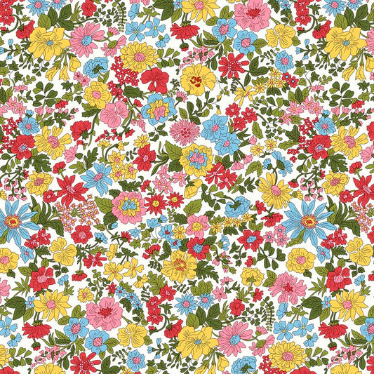Colorful floral pattern in blues, pinks, yellows, and reds amidst green foliage on a white quilting cotton