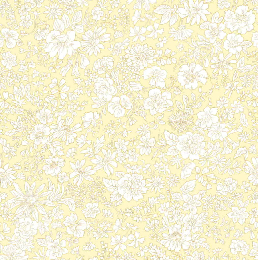 Ivory floral pattern on a pale yellow quilting cotton