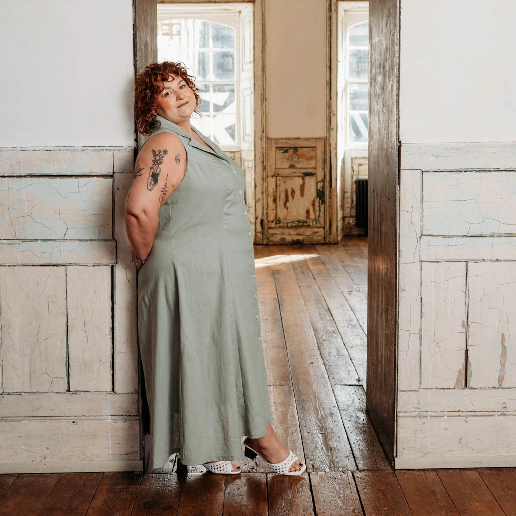 Woman wearing a long brown dress made using the Diana dress sewing pattern from NH Patterns