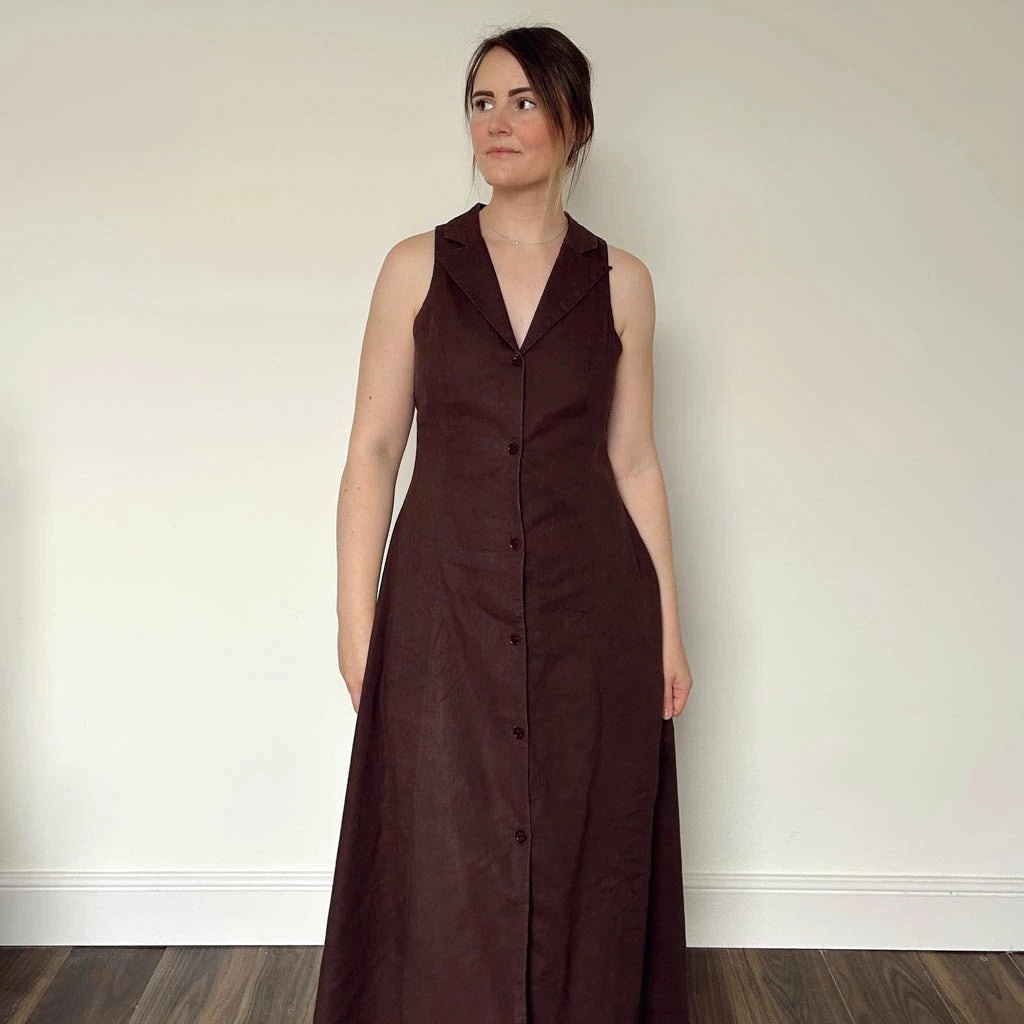 Woman wearing a long brown dress made using the Diana dress sewing pattern from NH Patterns