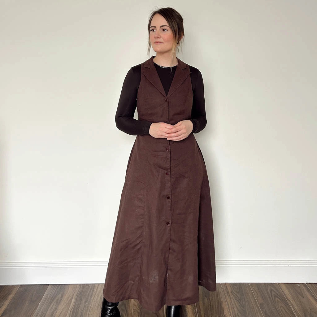 Woman wearing a long brown dress made using the Diana dress sewing pattern from NH Patterns