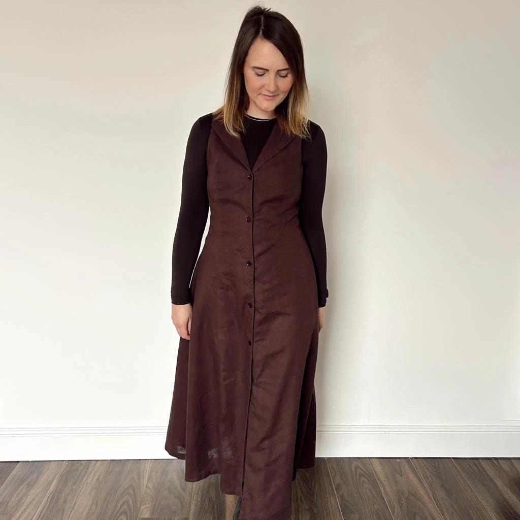 Woman wearing a long brown dress made using the Diana dress sewing pattern from NH Patterns