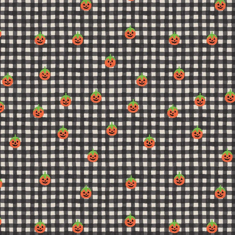 A repeating Halloween pattern featuring small orange jack-o'-lantern pumpkins with green tops on a black and white gingham check quilting cotton