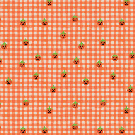 A repeating Halloween pattern featuring small orange jack-o'-lantern pumpkins with green tops on an orange and white gingham check quilting cotton