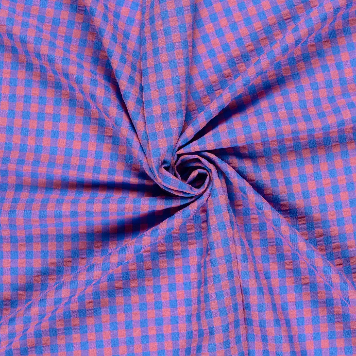 Blue and pink checkered fabric in a swirl pattern