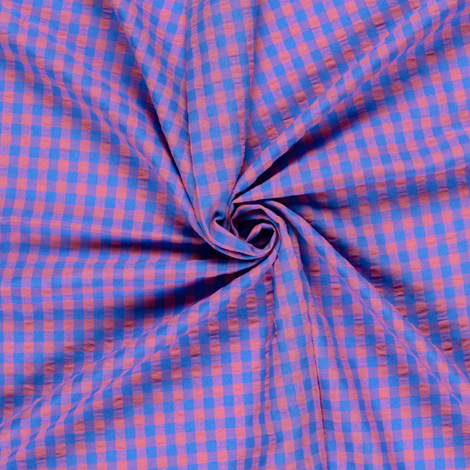 Blue and pink checkered fabric in a swirl pattern
