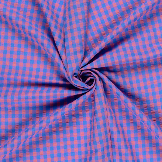 Blue and pink checkered fabric in a swirl pattern
