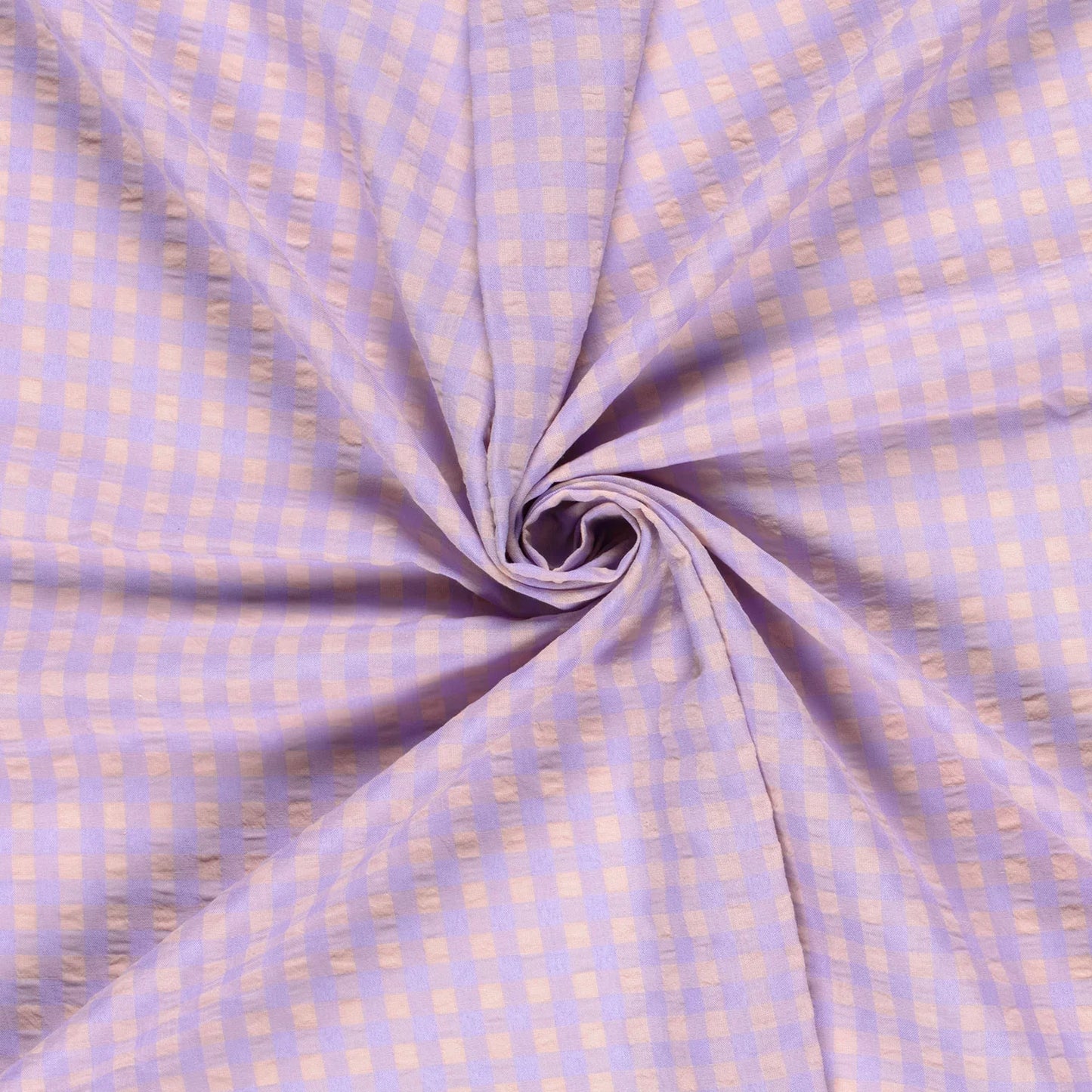 Folded fabric with a subtle check pattern on a light purple background