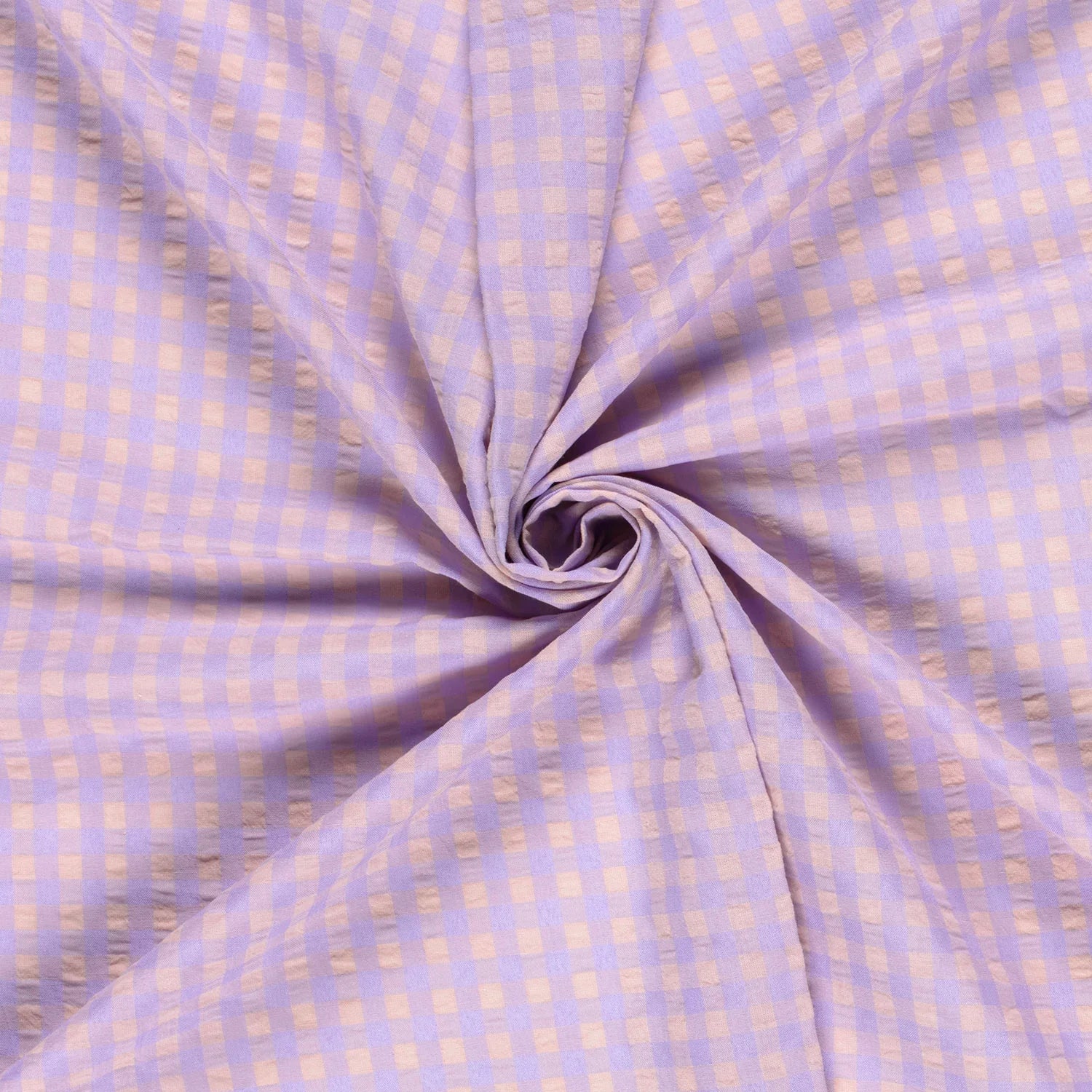 Folded fabric with a subtle check pattern on a light purple background