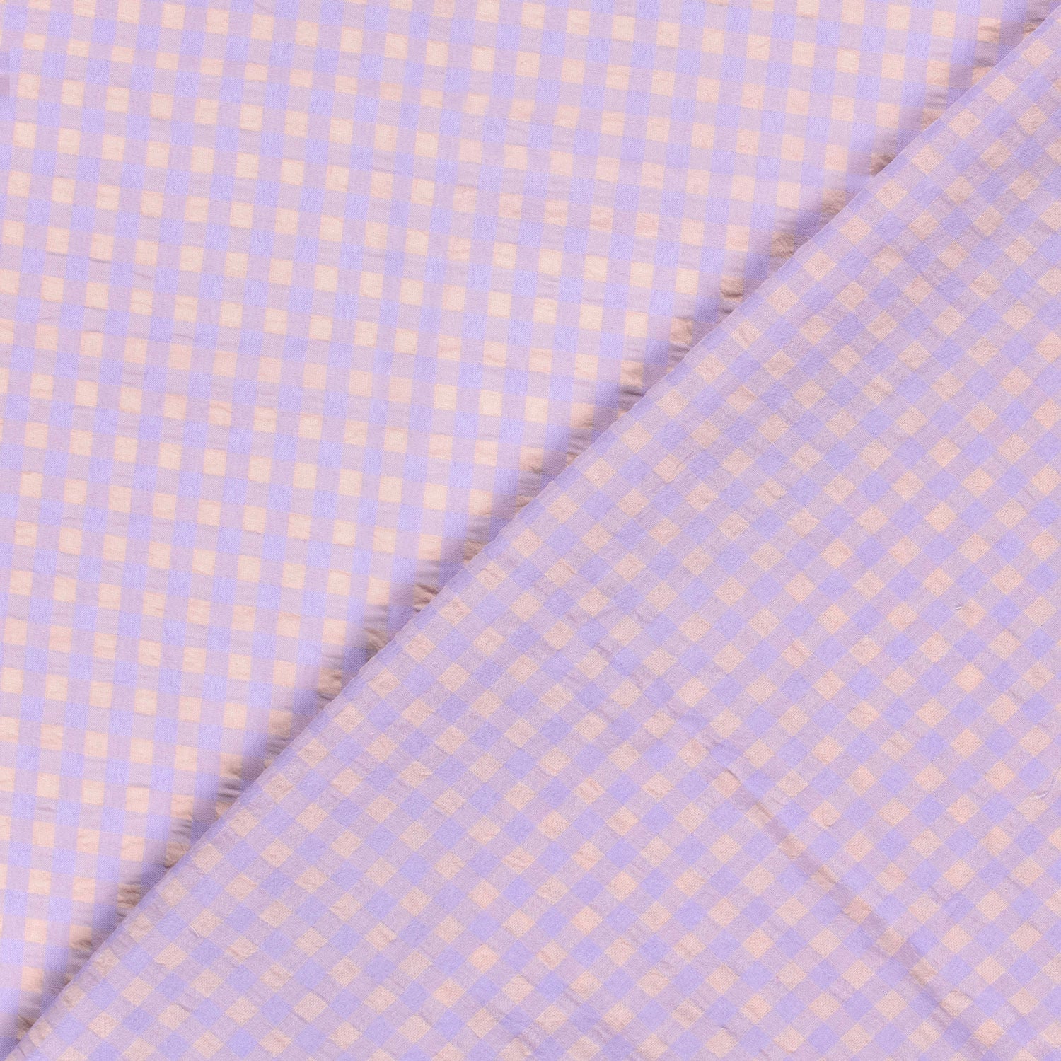 Fabric with a subtle checkered pattern on a light purple background
