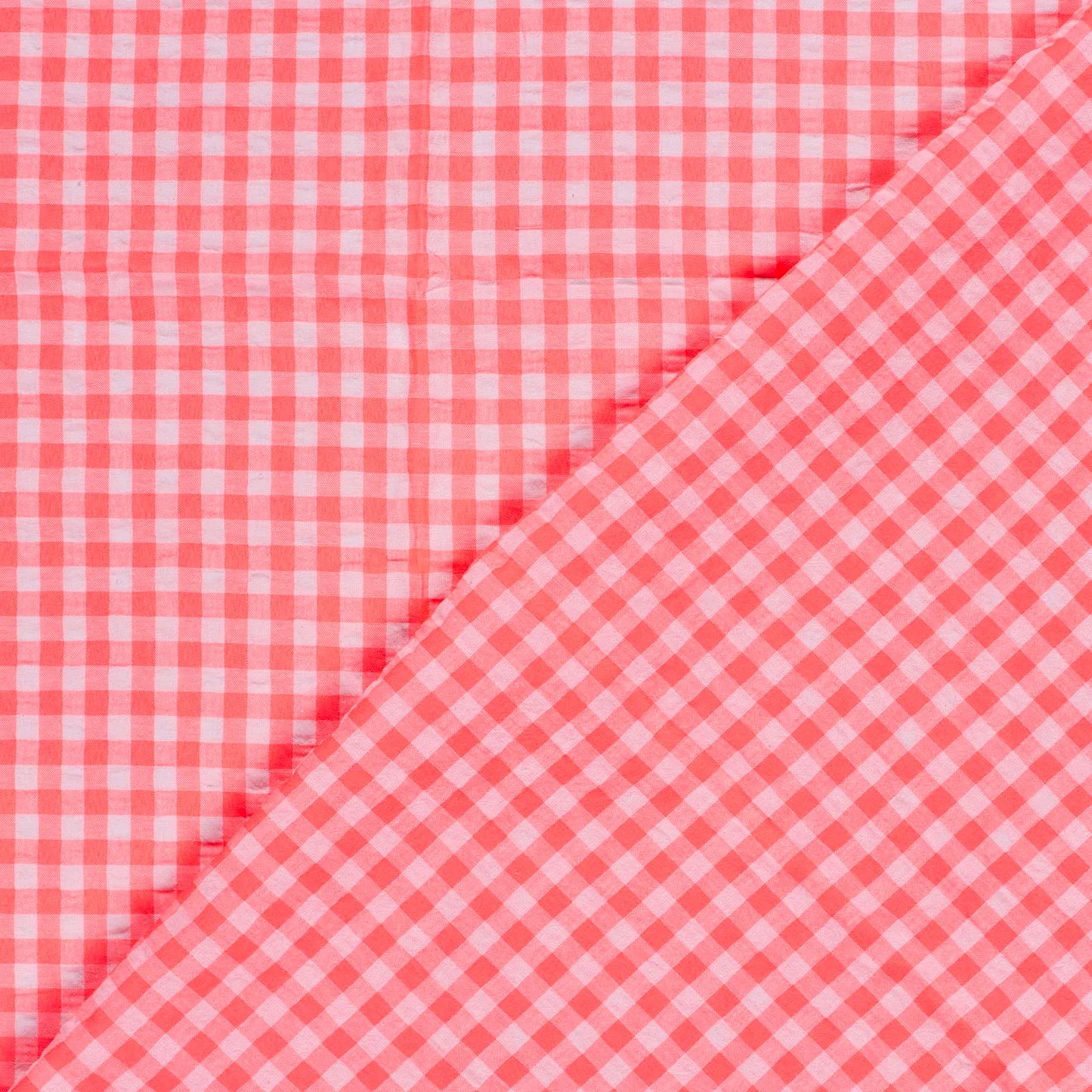 Pink and white gingham checkered fabric shown in a close-up diagonal fold.