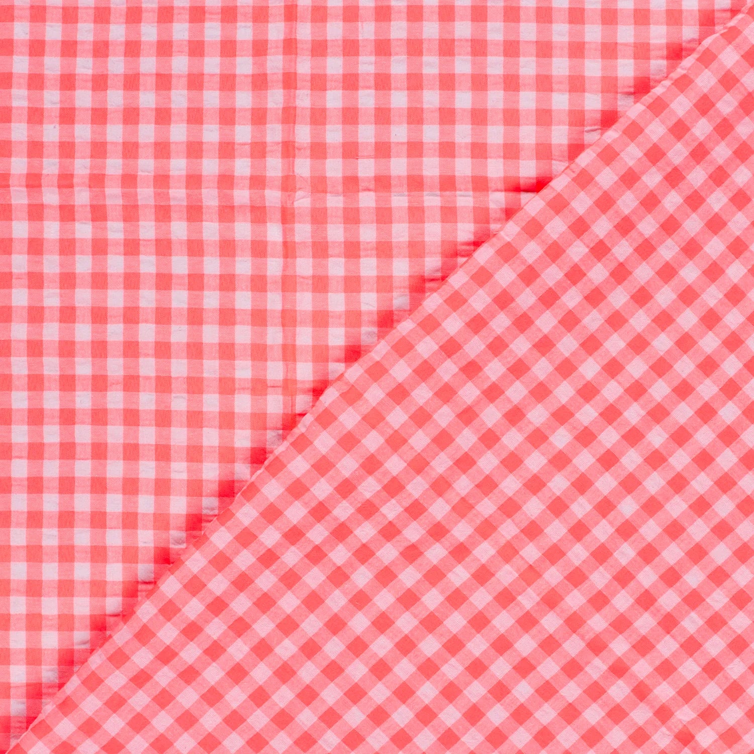 Pink and white gingham checkered fabric shown in a close-up diagonal fold.