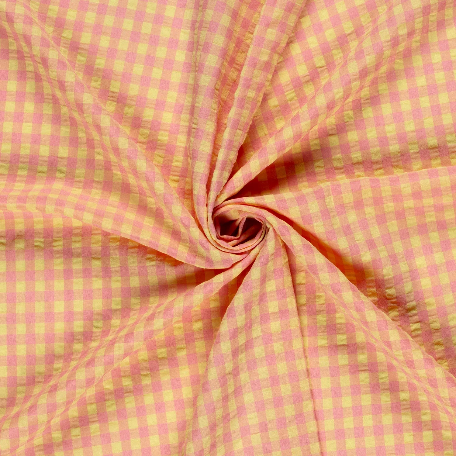 Pink and yellow checkered fabric in a swirl pattern