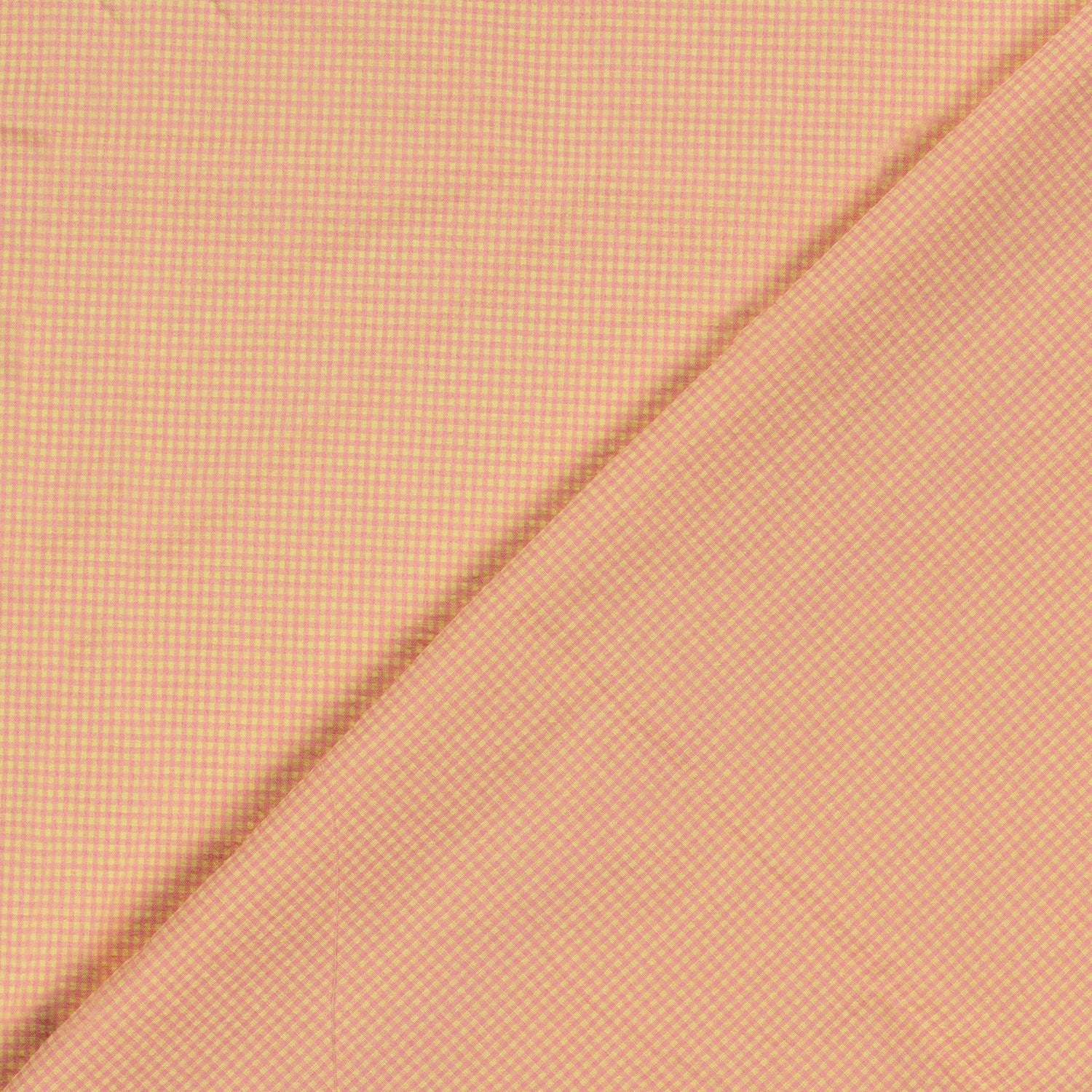 A close-up of pink and yellow fabric with a fine micro-checkered pattern, folded diagonally across the frame.