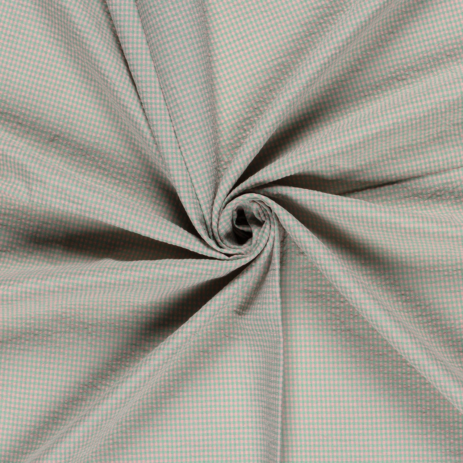 A close-up of a light gray and white gingham fabric, artistically swirled into a spiral pattern to show off its drape and texture.