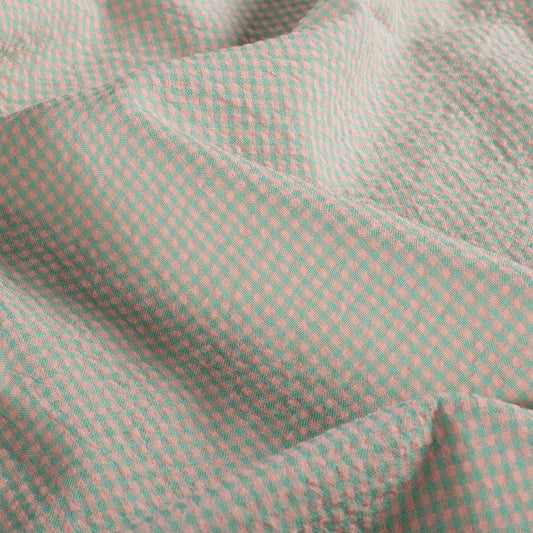 Close-up of a green and pink checkered fabric texture