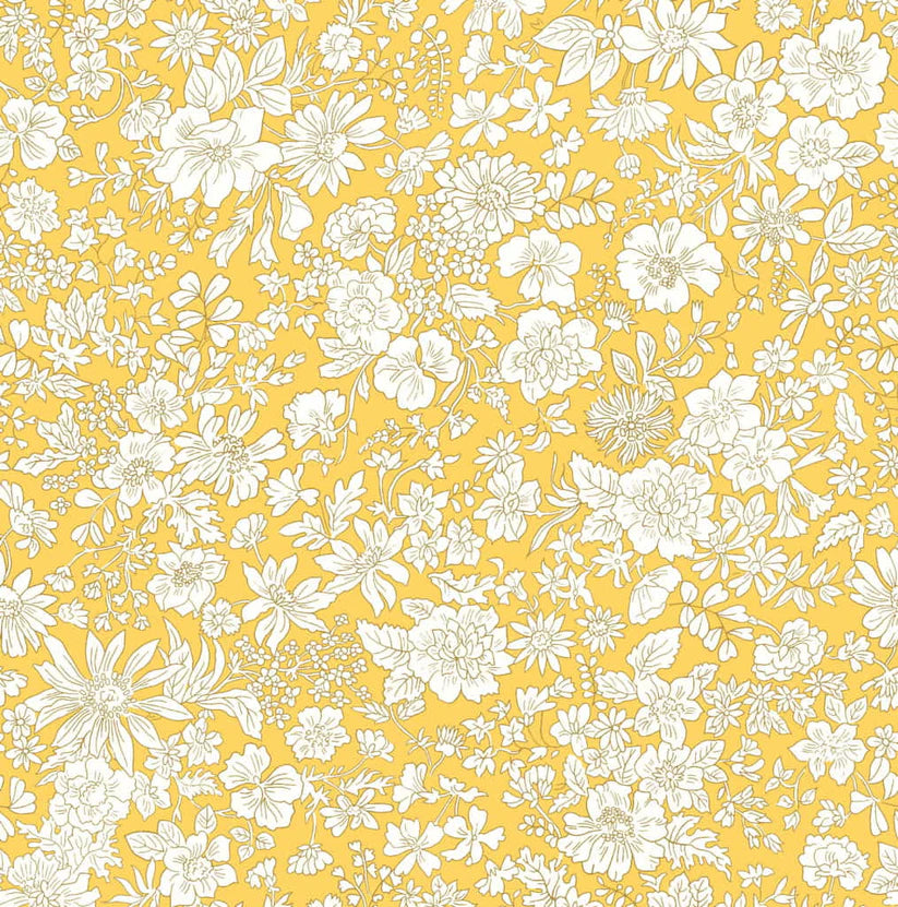 Ivory floral pattern on a bright yellow quilting cotton