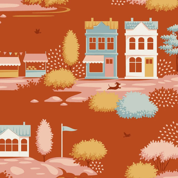 A repeating illustrated pattern of small houses, trees, bushes, a dog, and a flag on a warm rust-orange background.