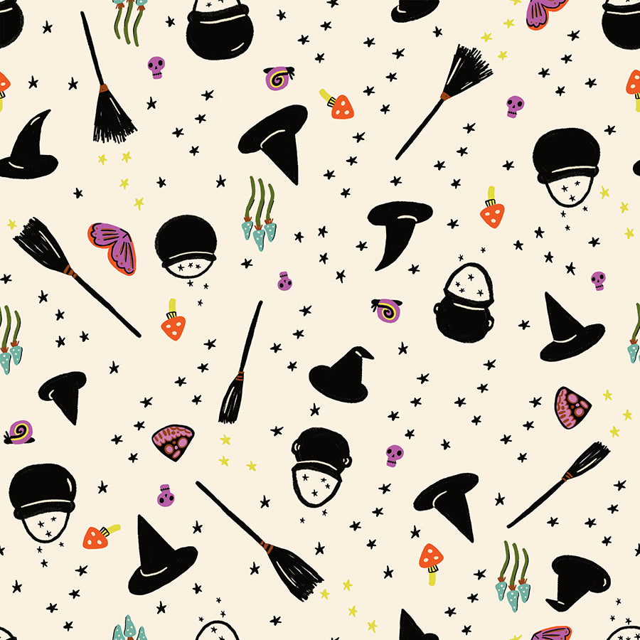 Halloween-themed pattern with witch hats, brooms, and candy on a beige quilting cotton