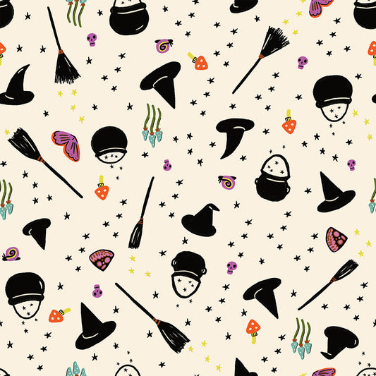 Halloween-themed pattern with witch hats, brooms, and candy on a beige quilting cotton